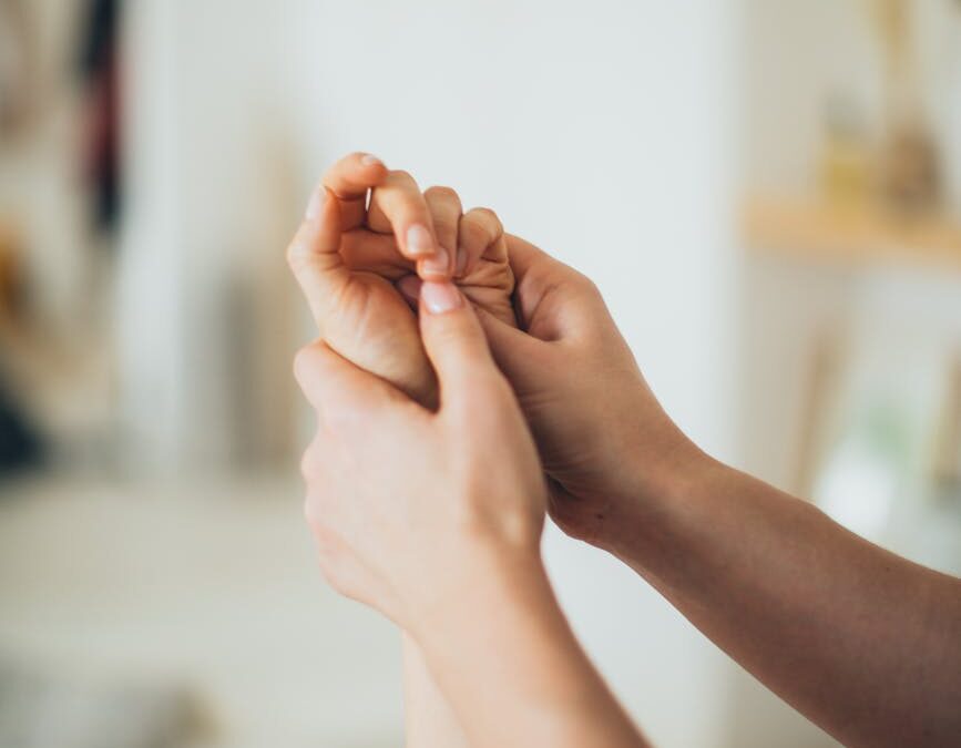 a person massaging a hand