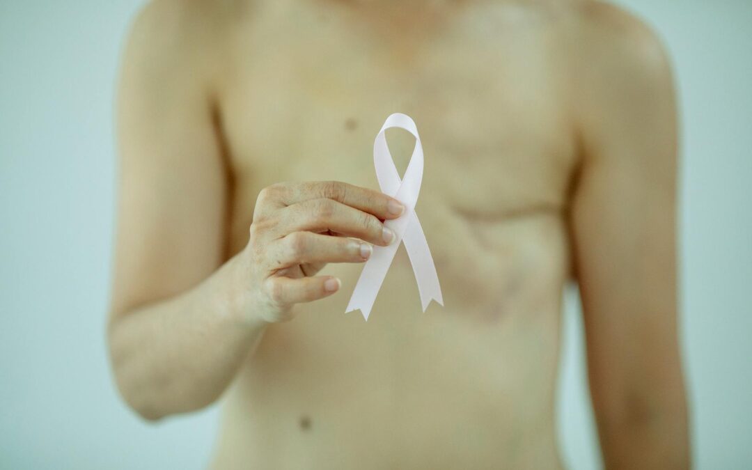 woman showing ribbon symbolizing breast cancer