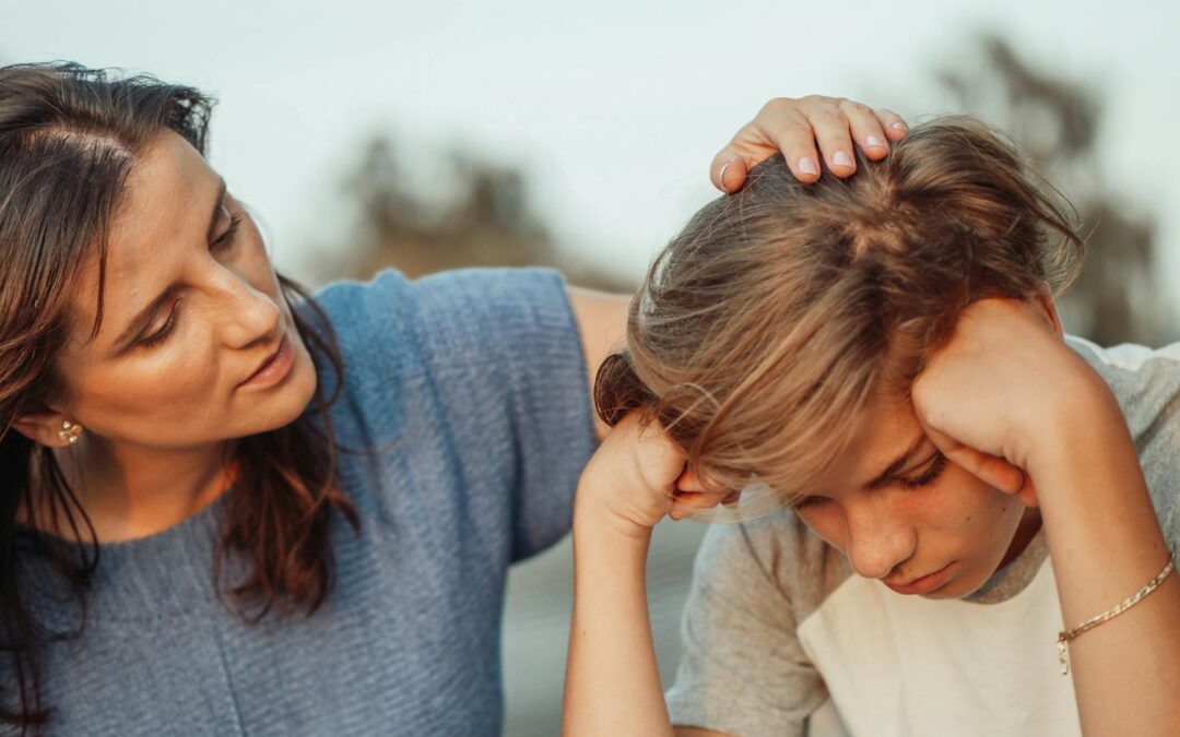woman in blue shirt talking to a young man in white shirt