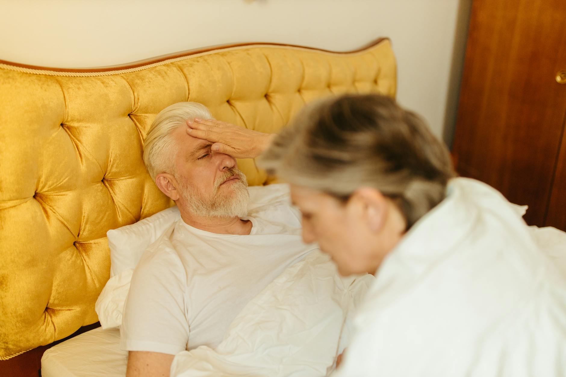 pexels-photo-8088595 elderly man lying down on bed looking sick