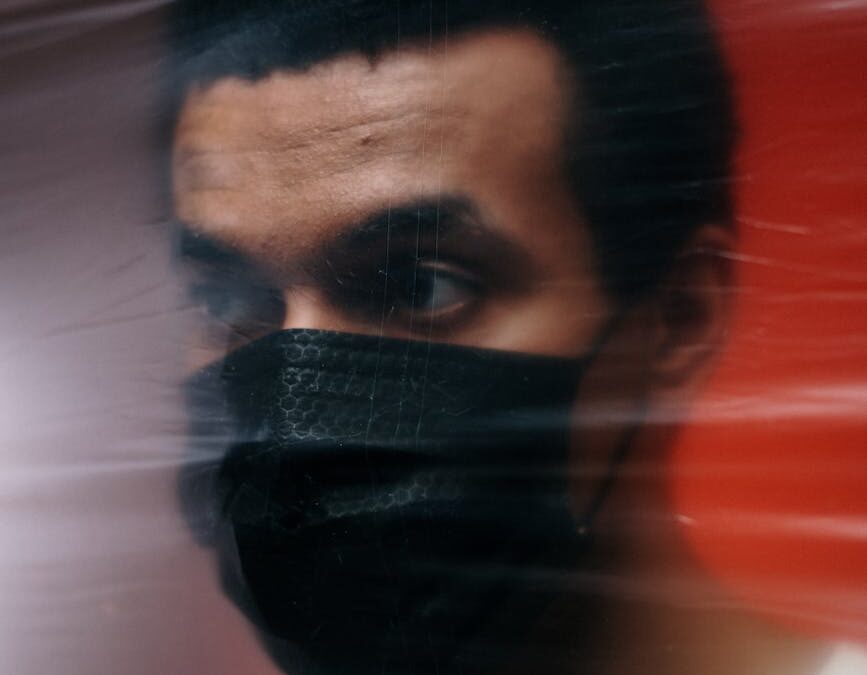 man wearing a black face mask