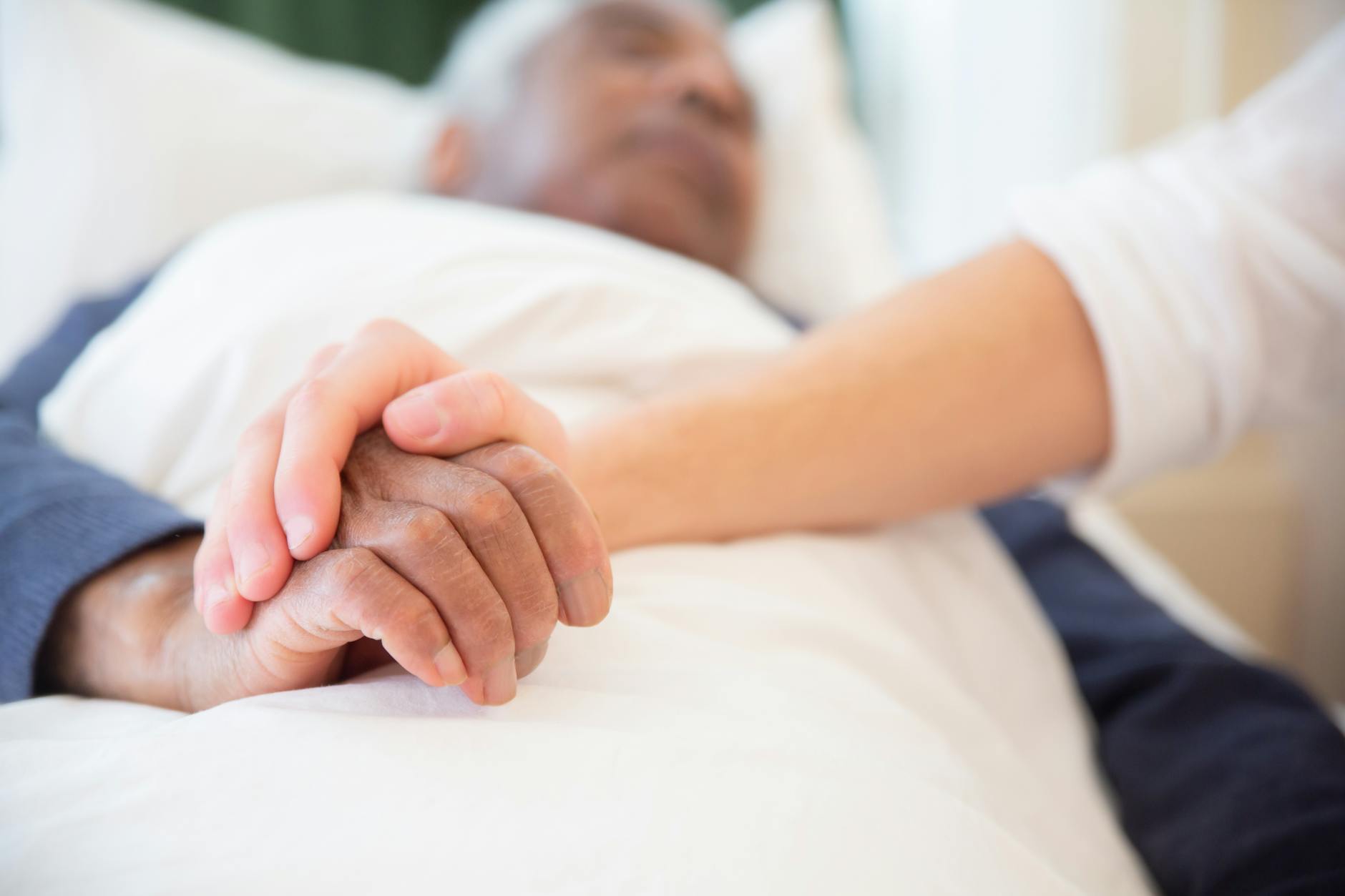 pexels-photo-7551677 young persons hand holding an old persons hand