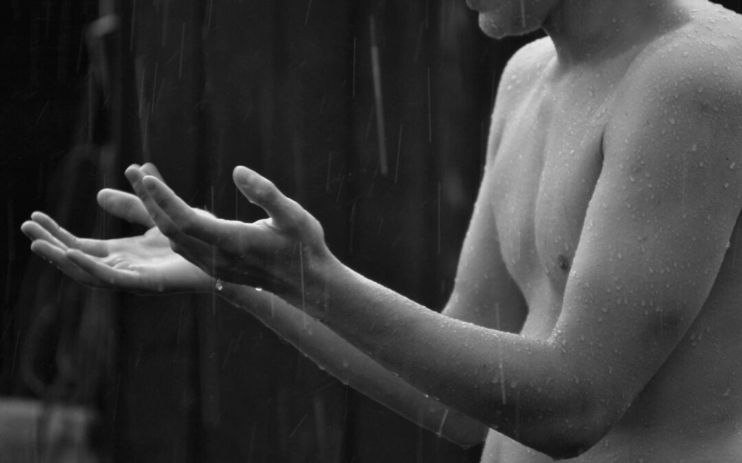 man standing under the rain