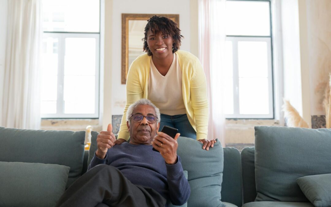 a man in blue sweater sitting on blue sofa