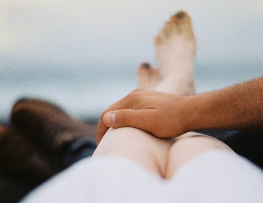 man s hand on a woman s leg