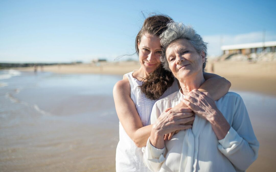 woman hugging her mother at the beach